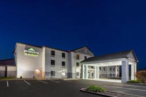 a rendering of a wynwright hotel at night at Wingate by Wyndham Grove City in Grove City