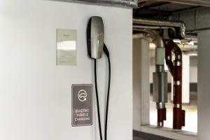 a device hanging on a wall in a room at Ramada by Wyndham Essen in Essen +125 photos