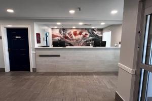 a lobby with a reception desk in a building at Hawthorn Extended Stay by Wyndham Hobbs in Hobbs