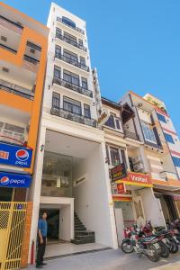 a man standing in front of a building at Liberty Hotel Đà Nẵng in Da Nang