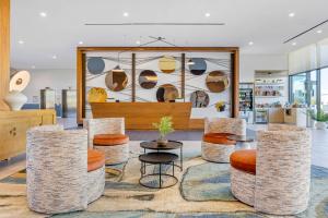 a store with stools and a table and chairs at Cambria Hotel Burbank Airport in Burbank