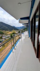 a train balcony with a view of the mountains at Naku homes in Dirang Dzong +45 photos