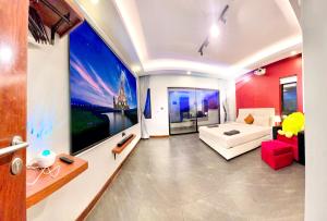 a living room with a large painting on the wall at Sky Hotel Sihanoukville - Free laundry in Sihanoukville +95 photos