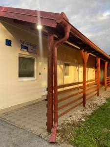 a metal roof on a house with a porch at Rooms Jelengrad in Petrijevci