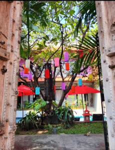 a tree with colorful decorations on it in front of a building at Villa Thapae in Chiang Mai