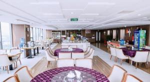 Lóc ÐaにあるKhach san Toan Thang Stoneの紫色のテーブルと椅子とテーブルとテーブルトップのあるレストラン