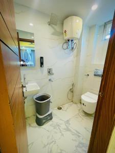 a bathroom with a toilet and a sink at Hotel Mount View Inn with terrace Ganga view in Rishīkesh