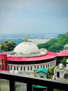 a large building with a dome on top of it at Hotel Mount View Inn with terrace Ganga view in Rishīkesh