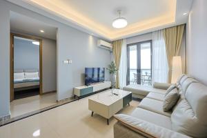 a living room with a couch and a tv at R&F Seine Region Family Suite Seaview 4BR 10-15pax Near R&F Mall CIQ in Johor Bahru