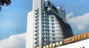 a tall white building with a sign in front of it at Kunming Tailong Hongrui Hotel in Kunming