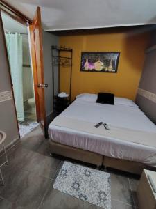 a bedroom with a large white bed and a bathroom at Habitación Privada con Aire in Cartagena de Indias +3 photos