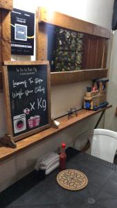 a kitchen with a counter with a chalkboard on it at Habitación Privada con Aire in Cartagena de Indias