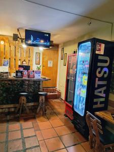 a room with a soda machine next to a bar at Habitación Privada con Aire in Cartagena de Indias