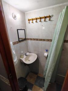 a small bathroom with a sink and a shower at Habitación Privada con Aire in Cartagena de Indias