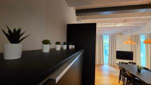 a kitchen with a black counter with potted plants on it at BG Life in Bergamo