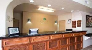 a reception desk with a clock on top of it at Quality Inn & Suites Rio Grande City in Rio Grande City +103 photos