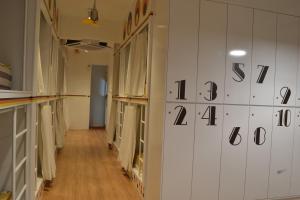 a hallway of a dressing room with clocks on the wall at Ringo's Foyer in Melaka