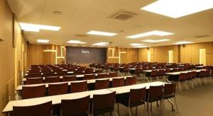 a lecture hall with tables and chairs and a chalkboard at KT&G Sangsangmadang Chuncheon Stay (Korea Quality) in Chuncheon