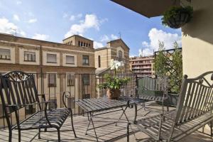 a patio with a table and chairs on a balcony at Hotel New Katsura in Sado