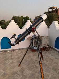 a telescope on a tripod in front of a building at Villa Barba Luxor in Luxor