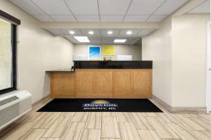 an office lobby with a desk with a sign on the floor at Days Inn by Wyndham Murphy in Murphy +35 photos