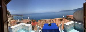 a person standing on a balcony looking at the water at Casa Vela B&B in Scilla