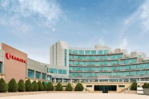 a large building with a sign on the side of it at Ramada by Wyndham Baku in Baku