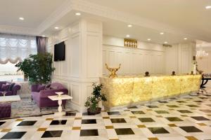 a lobby with a reception desk and purple chairs at Ramada by Wyndham Baku in Baku