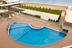 an overhead view of a swimming pool next to a beach at Ramada by Wyndham Baku in Baku