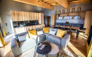 a living room with a couch and a table at Appartement de luxe les Arcs 4 chambres skis aux pieds in Arc 1800