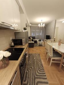 a kitchen and living room with a table and a dining room at Venus Deluxe Apartment in Strumica