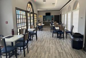 a dining room with tables and chairs in a restaurant at Days Inn by Wyndham Georgetown in Georgetown