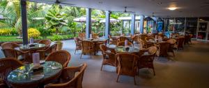 a row of tables and chairs in a restaurant at Heritage Park Hotel in Honiara