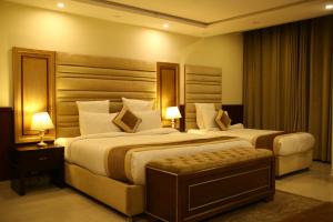 Ένα ή περισσότερα κρεβάτια σε δωμάτιο στο City Oasis Hotel