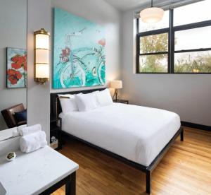 a bedroom with a large white bed and a window at Hotel Grinnell, Ascend Hotel Collection in Grinnell