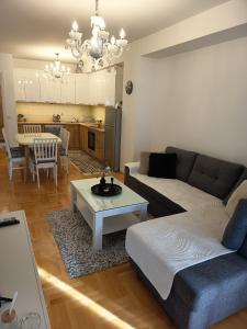 a living room with a couch and a table at Venus Deluxe Apartment in Strumica