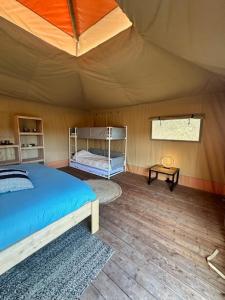 a bedroom with a bed in a tent at Safari Lodge at Back to Basic in Zwaanshoek