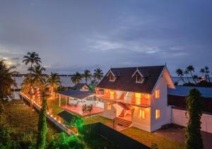 an aerial view of a house with lights at Celestiah Lakeshore Kochi by VOYE HOMES - Peaceful Backwater Stay in Kumbalangi in Cochin