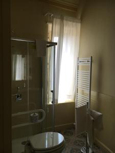 a bathroom with a toilet and a shower and a window at Hotel Sant'Anna in Floresta