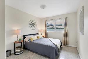 a bedroom with a bed and a window at Charming 3BR Retreat Near Sarasota Beaches in Sarasota