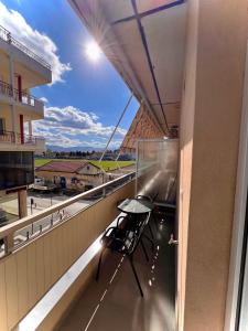 a chair on the balcony of a building at Voulas Apartment 2 in Ptolemaida