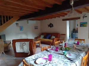 a living room with a table and a couch at Au repos de la Sioule in Menat