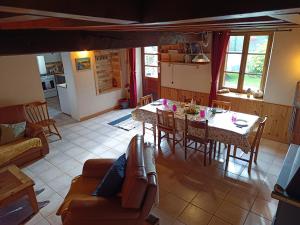 a kitchen and living room with a table and chairs at Au repos de la Sioule in Menat
