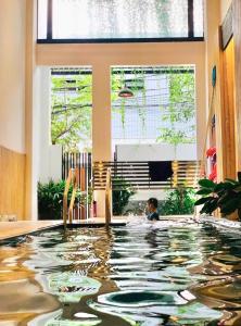 a child swimming in an indoor swimming pool at The Little Danang in Da Nang