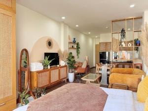 a bedroom with a bed and a living room at The Little Danang in Da Nang