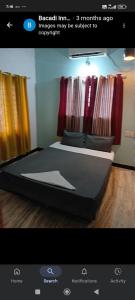 a picture of a bedroom with a bed in a room at Bacadi inn Service apartment in Edappally