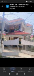 a picture of a fence in front of a building at Bacadi inn Service apartment in Edappally