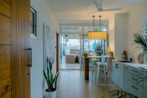 a kitchen with a table and a counter top at Nivara Stays Kukatpally - A boutique Hotel Brand in Hyderabad