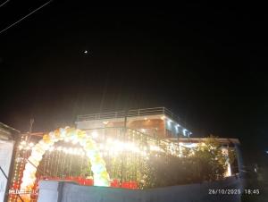 a building with an arch in front of it at night at Sai Swastik Homestay Hampi in Munirābād +6 photos