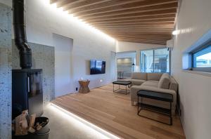 a living room with a couch and a fireplace at Sou in Isahaya